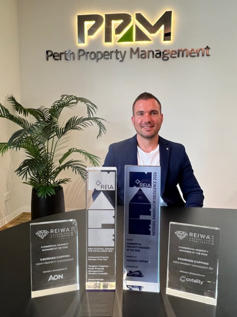 Table of award trophies with Director Of Commercial Property Management, Vaughan Copping