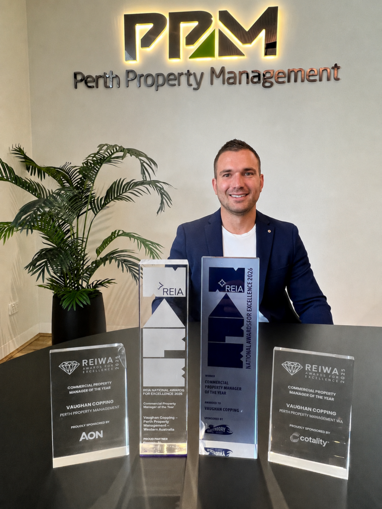 Table of award trophies with Director Of Commercial Property Management, Vaughan Copping